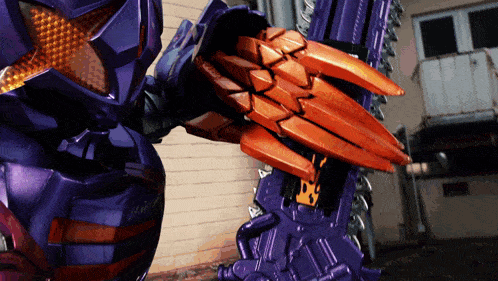 a person in a purple and orange costume holding a large sword