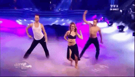 a group of dancers are performing on a stage in front of a sign that says tfi en direct