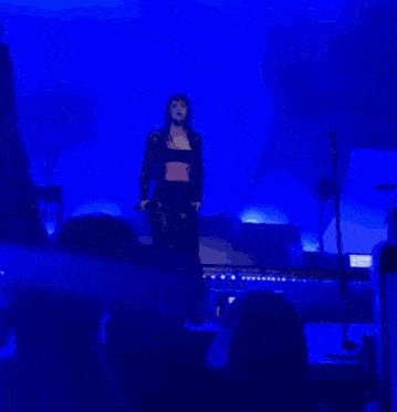 a blurred image of a person in a dark room with a sign that says cultureheads