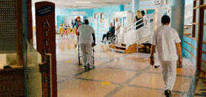 a person in a wheelchair is walking in a hallway with a sign that says atte