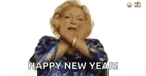 an elderly woman is saying `` happy new year '' while wearing a blue jacket .