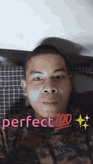 a man in a camo shirt with perfect 700 written on his face