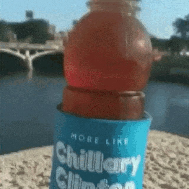 a bottle of chillary clinton sits in a blue can holder