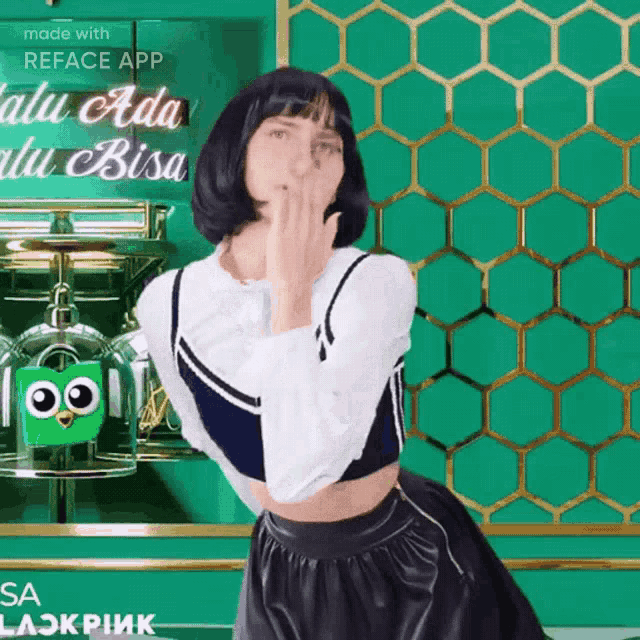 a woman blowing a kiss in front of a green wall that says reface app