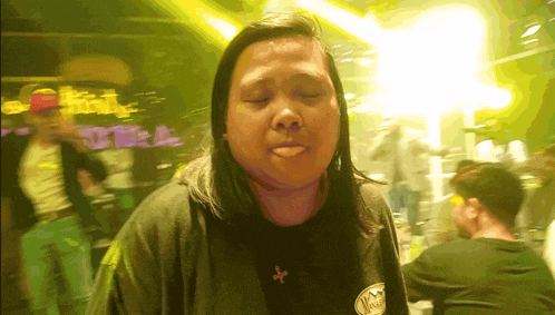 a woman wearing a black shirt with a sticker on it that says ' vodka ' on it