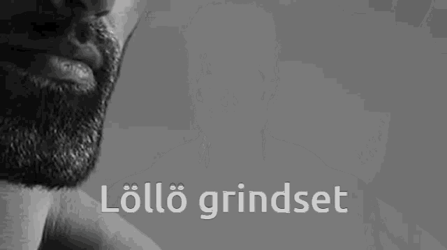 a black and white photo of a man with a beard and the words lollo grindset .