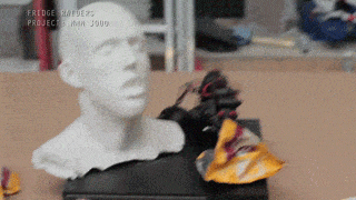 a statue of a man 's head sits on a table with the words fridge rappers project in the upper right corner