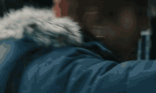a close up of a person 's face with a fur hood .