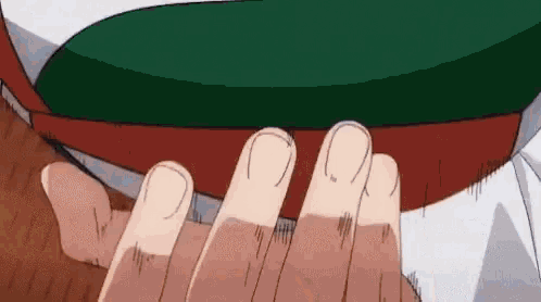 a close up of a person 's hand touching another person 's chest .