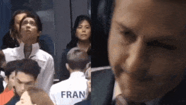 a group of people standing next to each other in a room and a man wearing headphones .