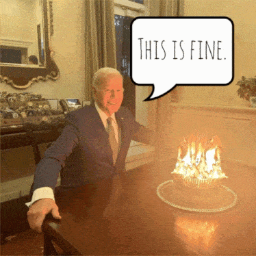 a man sitting at a table with a cake on it and a speech bubble saying this is fine