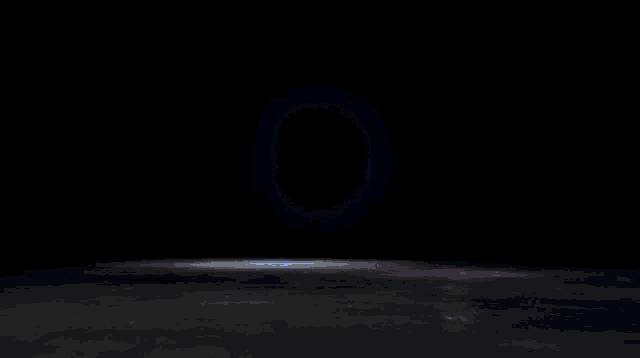 a dark background with a purple light coming out of it
