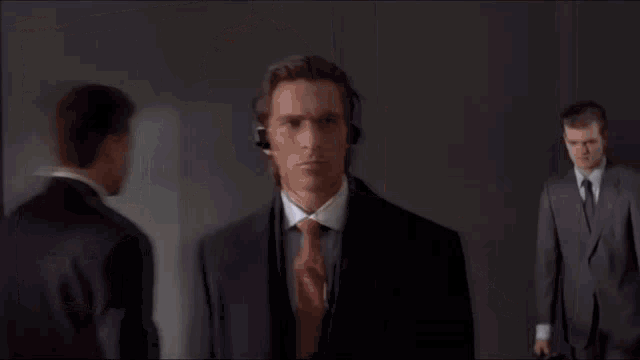 a man in a suit and tie with headphones on his head