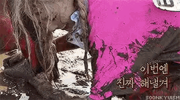 a girl is laying in the mud with korean writing on the bottom right