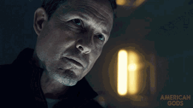 a close up of a man 's face with the words american gods in the corner