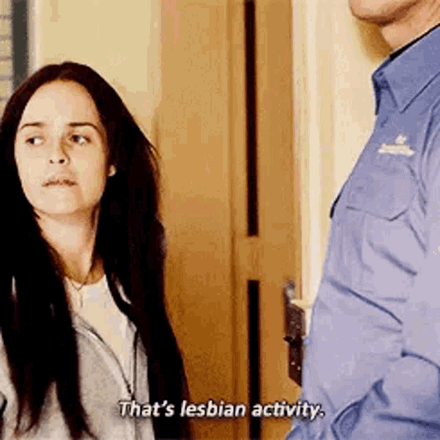 a woman is standing next to a man and saying `` that 's lesbian activity '' .