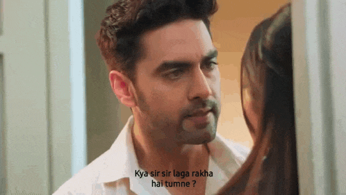 a man and a woman are looking at each other and the man is asking the woman .