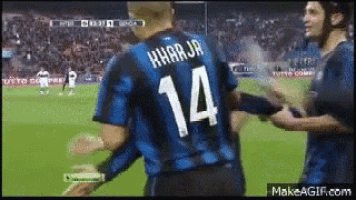 a soccer player with the number 14 on the back of his shirt