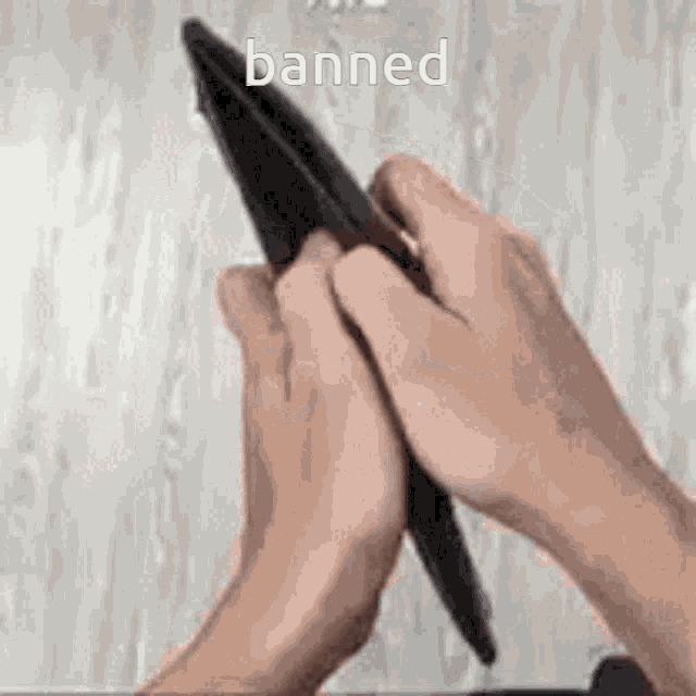 a person is holding an empty wallet in their hands with the word banned written on the bottom .