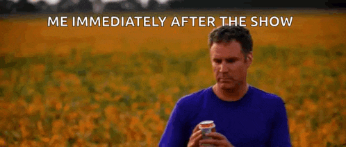 a man is standing in a field of sunflowers holding a can of soda .