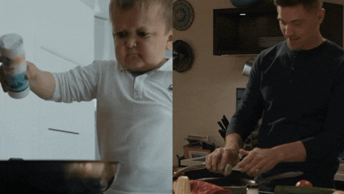a little boy is holding a salt shaker and a man is cooking