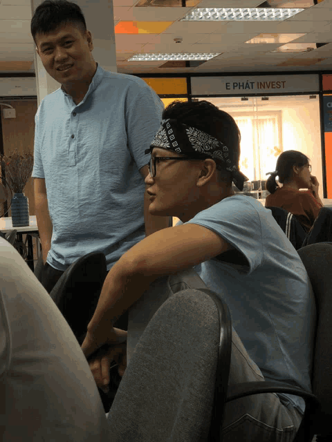a man wearing a bandana that says ephat invest on it