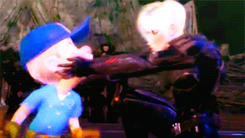 a cartoon character in a blue shirt is being held by another character