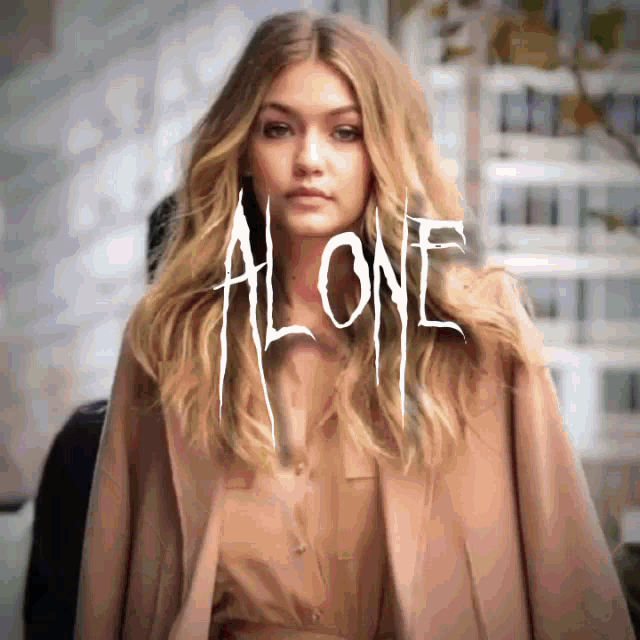 a woman is standing in front of a sign that says " alone "