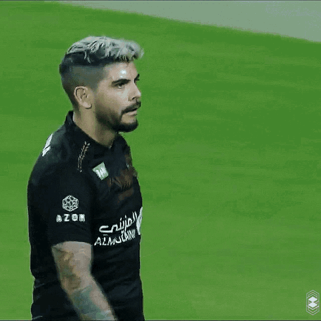 a soccer player wearing a black shirt that says azor