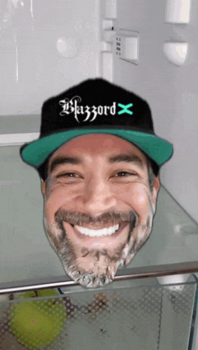 a man wearing a blizzard hat is smiling