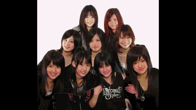 a group of young girls are posing for a picture and one of them is wearing a shirt that says triomf style