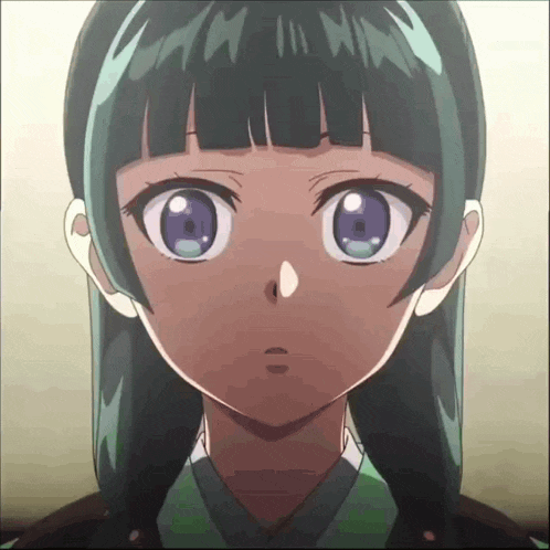 a close up of a girl 's face with a surprised look on her face