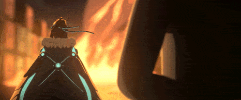 a person in a cape stands in front of a large fire