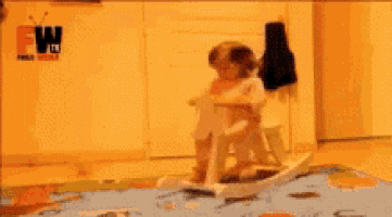 a person is playing with a toy in front of a ew tv sign