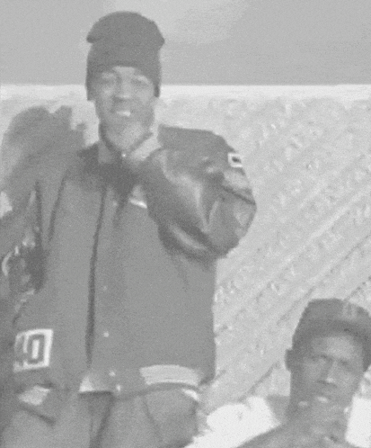 a man wearing a beanie and a jacket with the number 10 on it