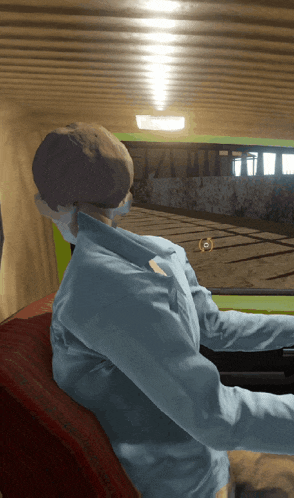 a man in a blue shirt sits in a car looking out the window