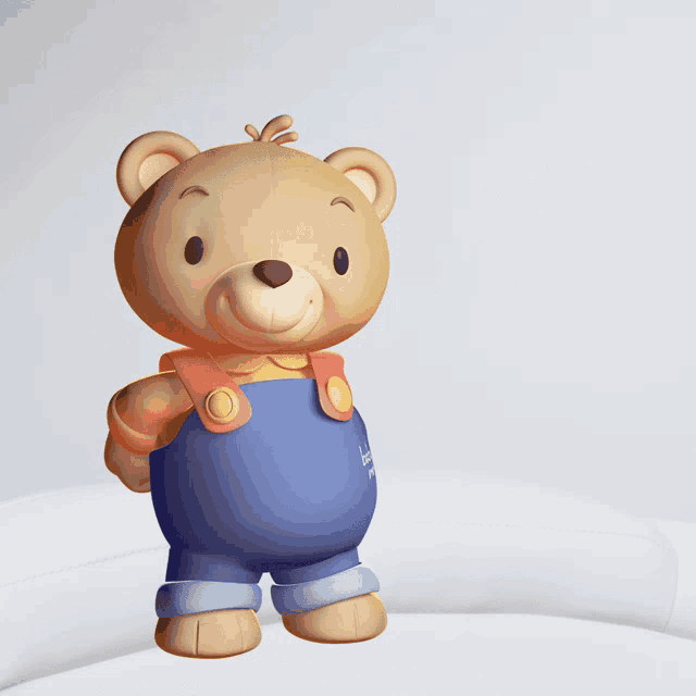 a teddy bear in blue overalls is standing in front of a sign that says abrazos