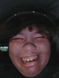 a close up of a person 's face with a big smile