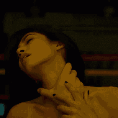 a man holds a woman 's neck with his hand