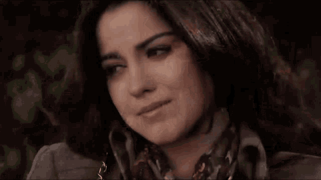 a close up of a woman 's face with her eyes closed and her mouth open .