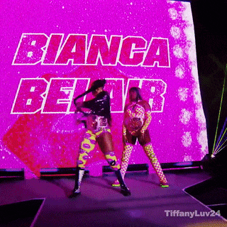two women are dancing in front of a large screen that says bianca beltr .