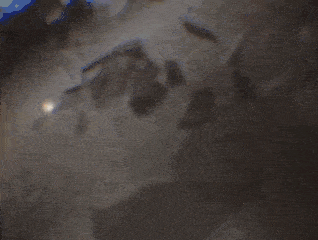 a close up of a water surface with a reflection of the sun