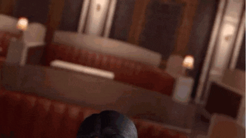 a man wearing a eye patch is standing in a room .