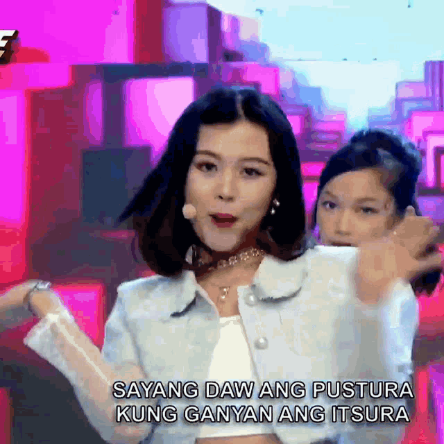 two women are dancing on a stage with the words sayang daw ang pustura kung ganyan ang itsura behind them
