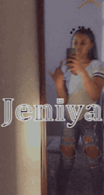 a girl is taking a selfie in front of a mirror with the name jeniya written on the bottom