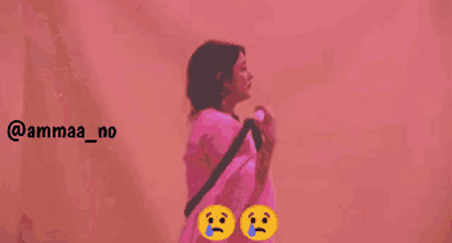 a man and a woman standing next to each other with a pink background