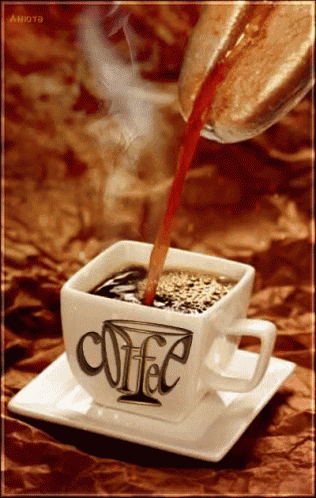 coffee is being poured into a cup that says coffee on it
