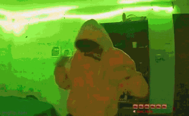 a pixelated image of a person in a hoodie with a green background