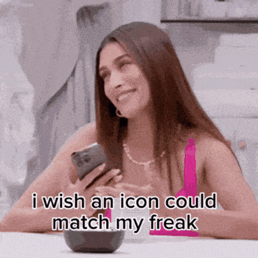 a woman is smiling while holding a cell phone and saying i wish an icon could match my freak