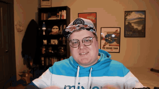 a man wearing glasses and a blue and white hoodie with the word mix on it